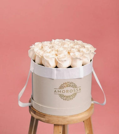 AMOROSSA - LAVAN 24 - Elegant white roses arranged in a round gray box with ribbon handles for regalar flores and enviar flores delivery rapido de .
